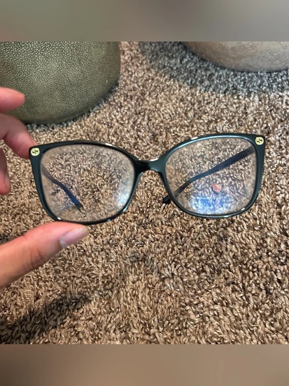 Gucci GG0026O eyeglasses in black with gold logo accents on the temples
